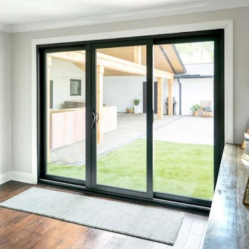 Beautifully working black three-panel sliding glass door opening to a patio