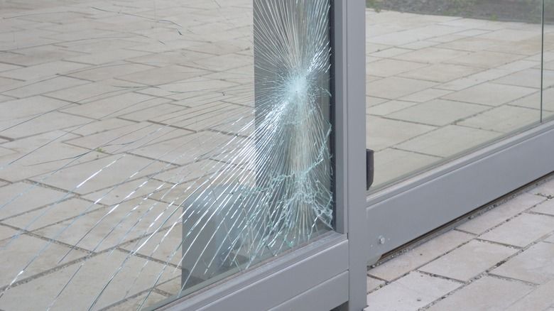 Shattered, cracked sliding glass door pane that needs replacement