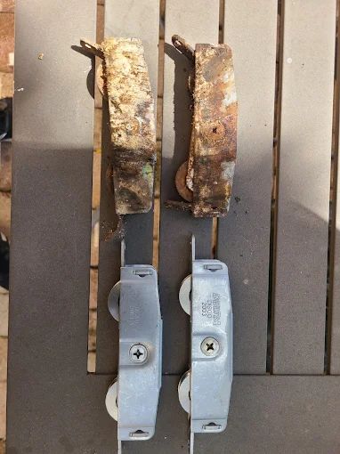 Old corroded sliding door rollers removed during a repair
